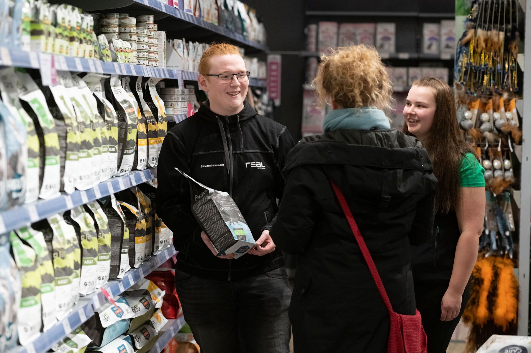 Elev på APL som hjälper en kund välja hundfoder