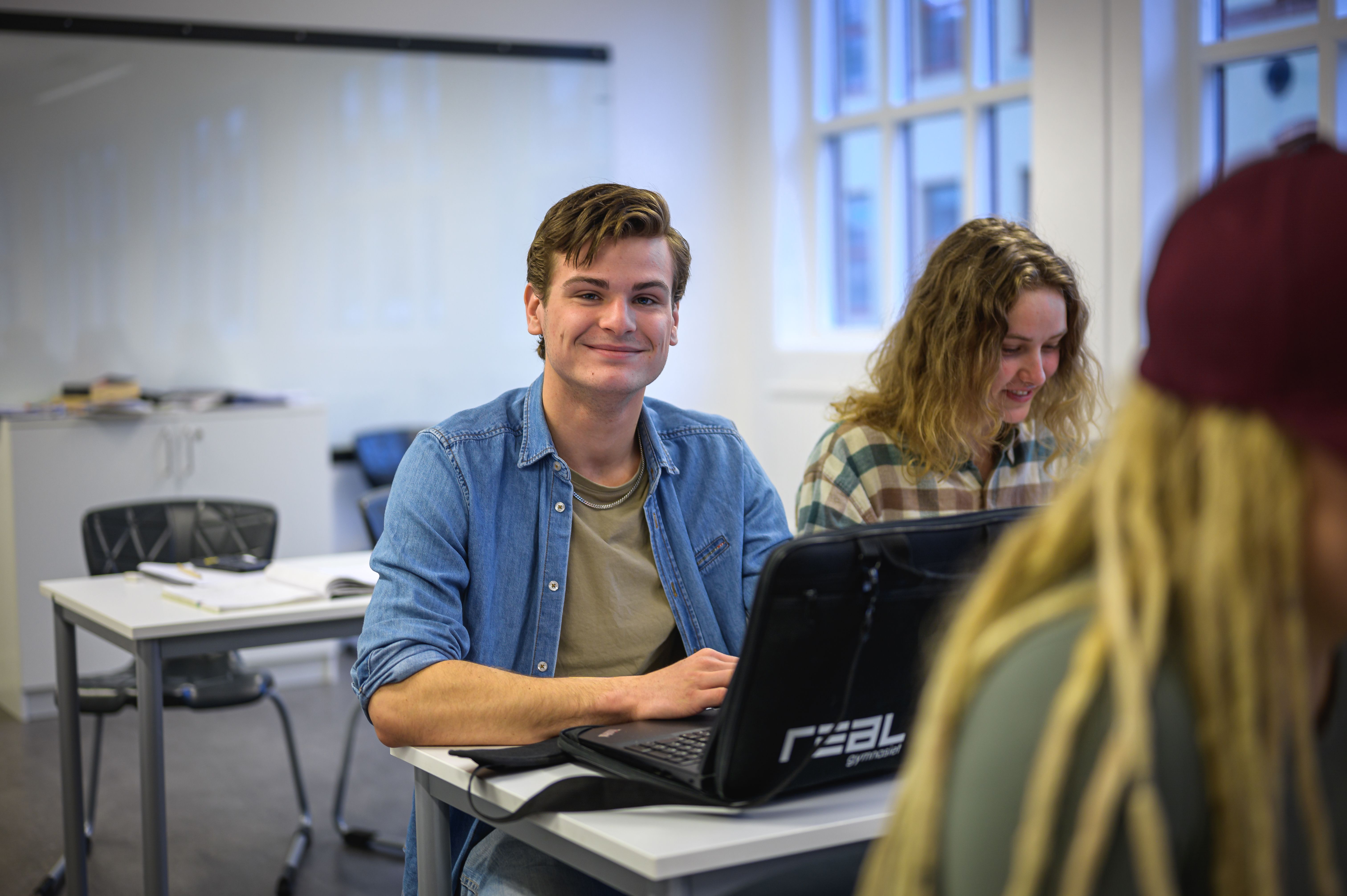 realelever sitter bredvid varandra i skolsal