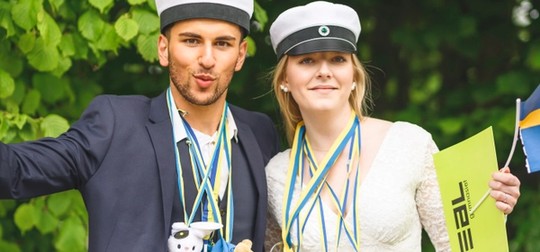 Kille och tjej i studenmössor