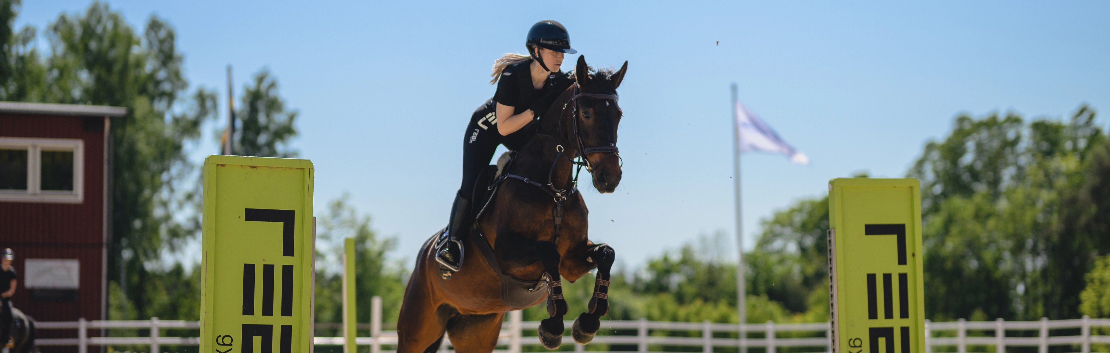 elev och häst på väg över hinder