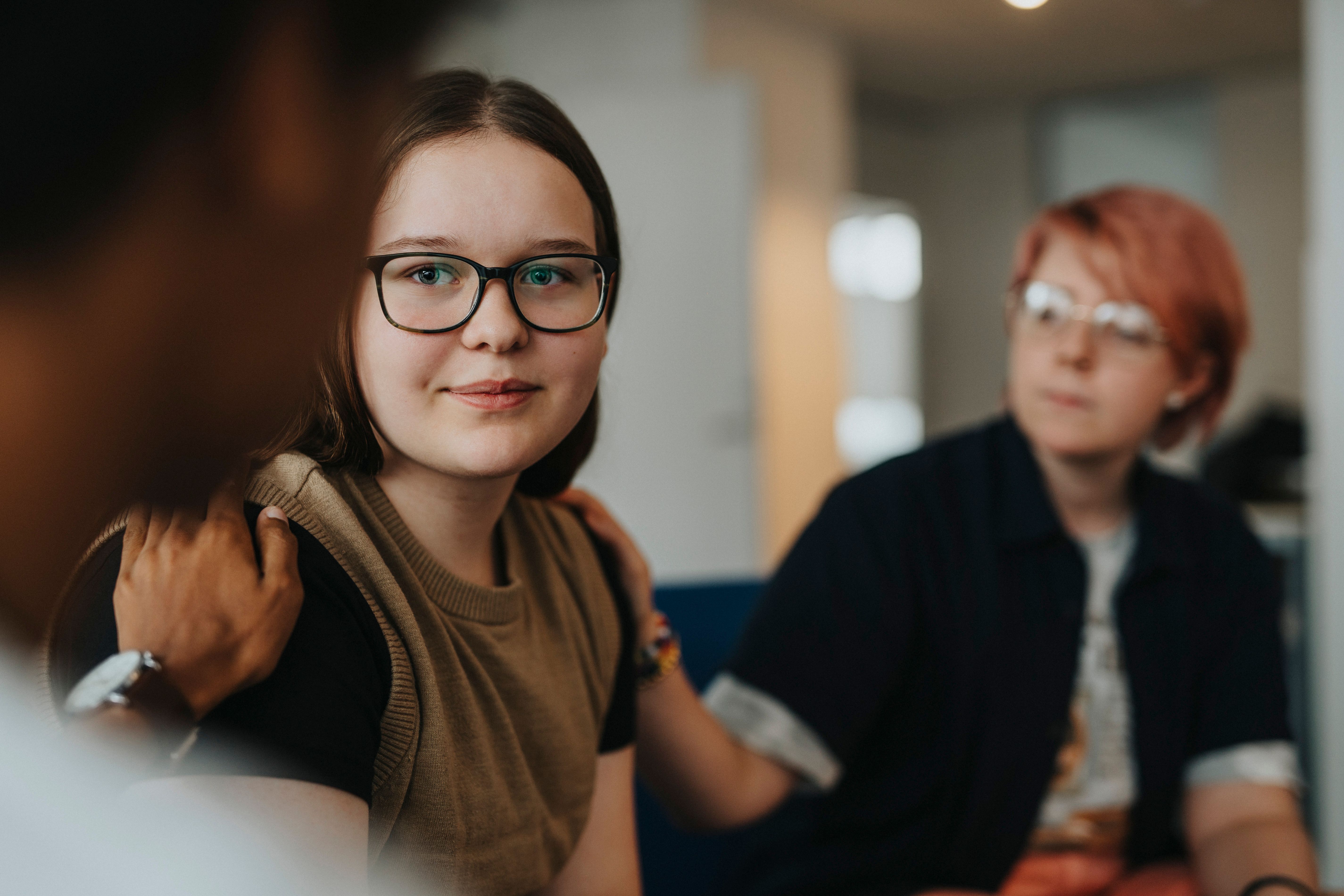 Elev som får stöd från personal med hand på axeln