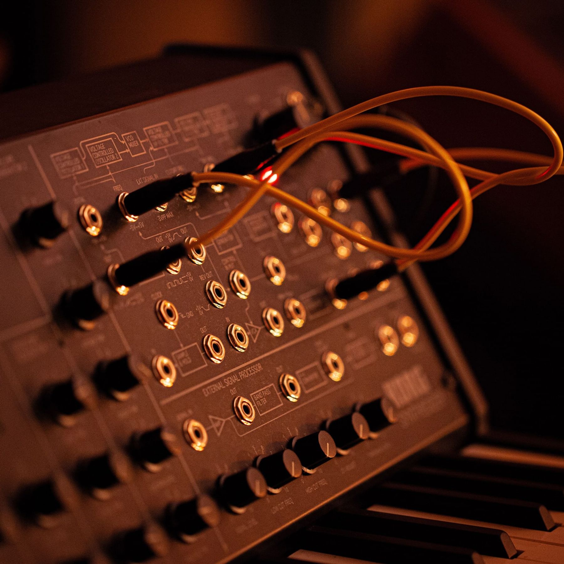 Roland Juno-106 in amber light Key+Needle Studios A Room