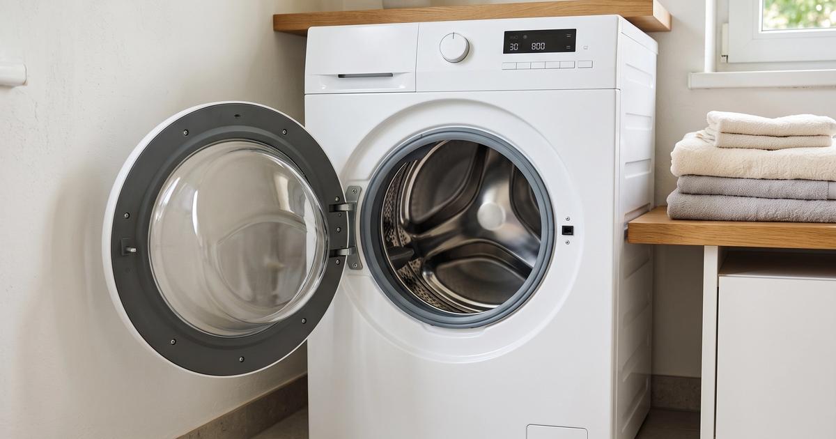 A clean front-loading washing machine with its door left open.