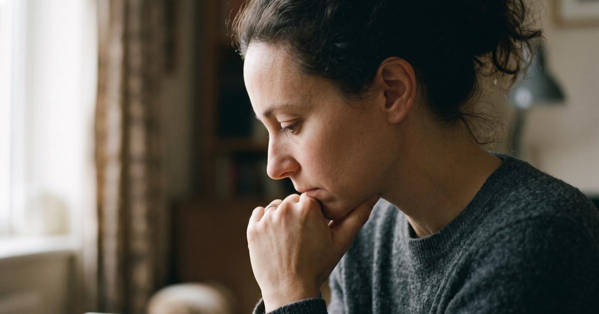 A person in profile with a thoughtful, searching expression.