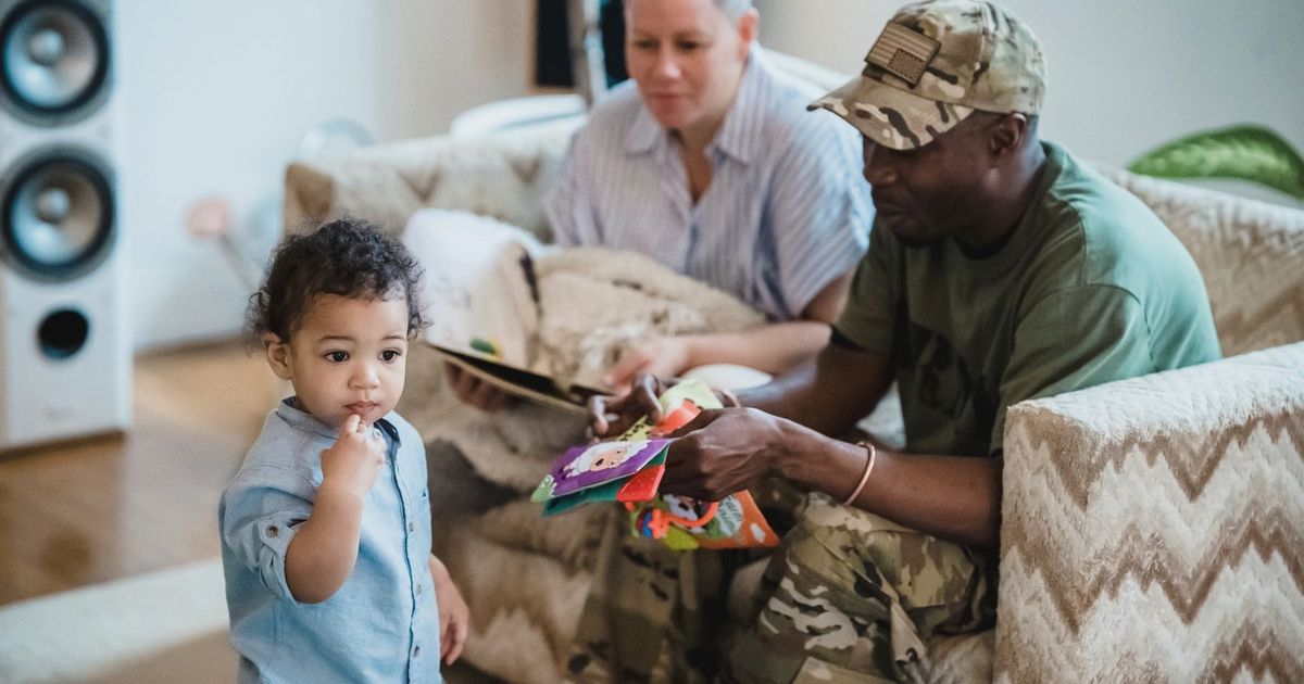 A playful moment at home showing a toddler with parents, capturing family bonding.