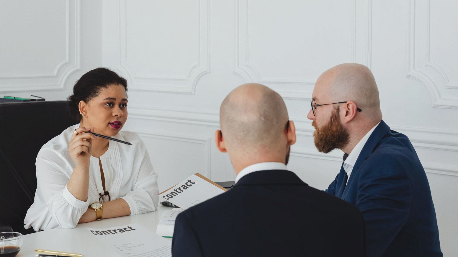 Business colleagues meeting in an office to discuss a contract negotiation.