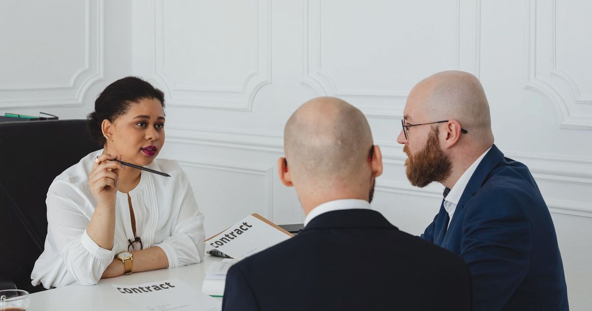 Business colleagues meeting in an office to discuss a contract negotiation.