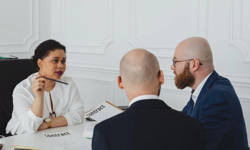 Business colleagues meeting in an office to discuss a contract negotiation.