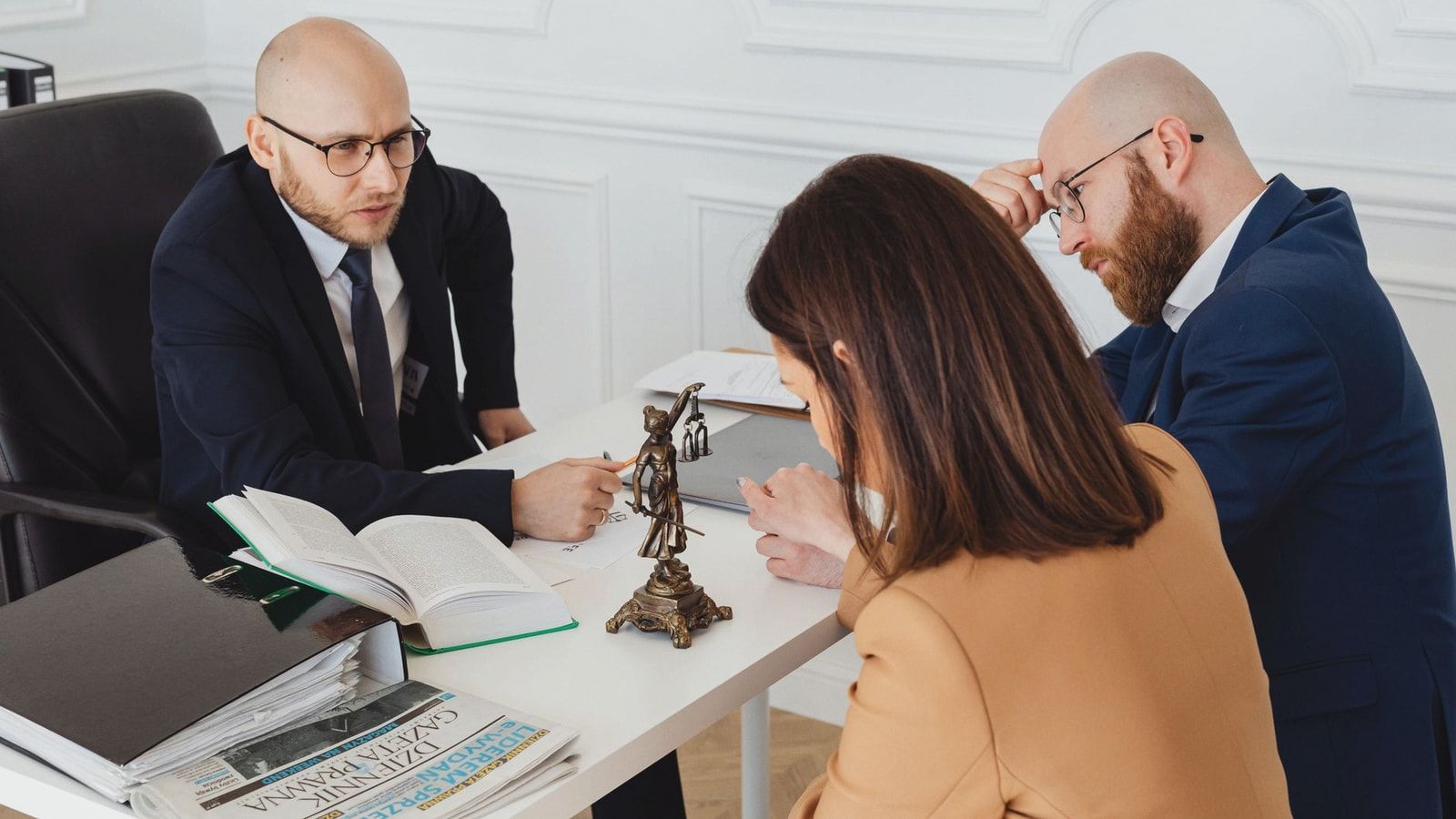 Lawyer consulting clients in a modern office setting, serious discussion.
