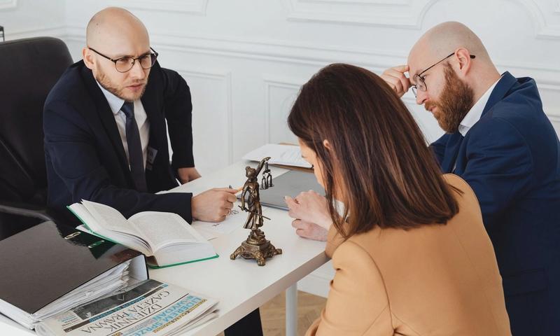 Lawyer consulting clients in a modern office setting, serious discussion.