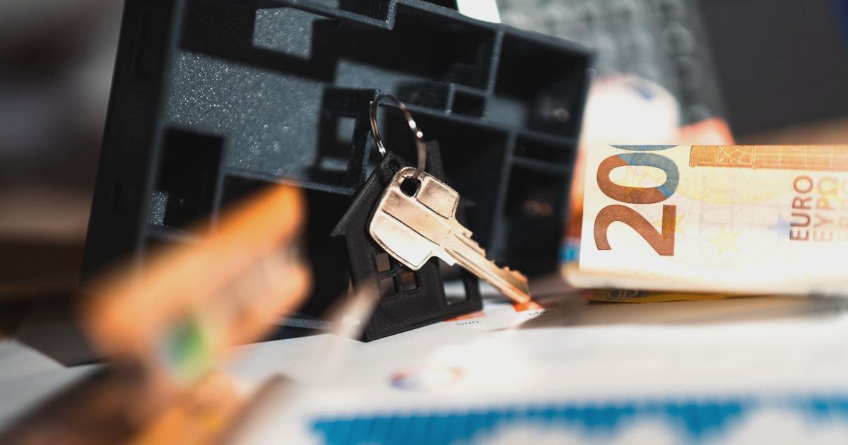 Keys with a house model, Euro bills, and charts suggesting real estate and financial themes.
