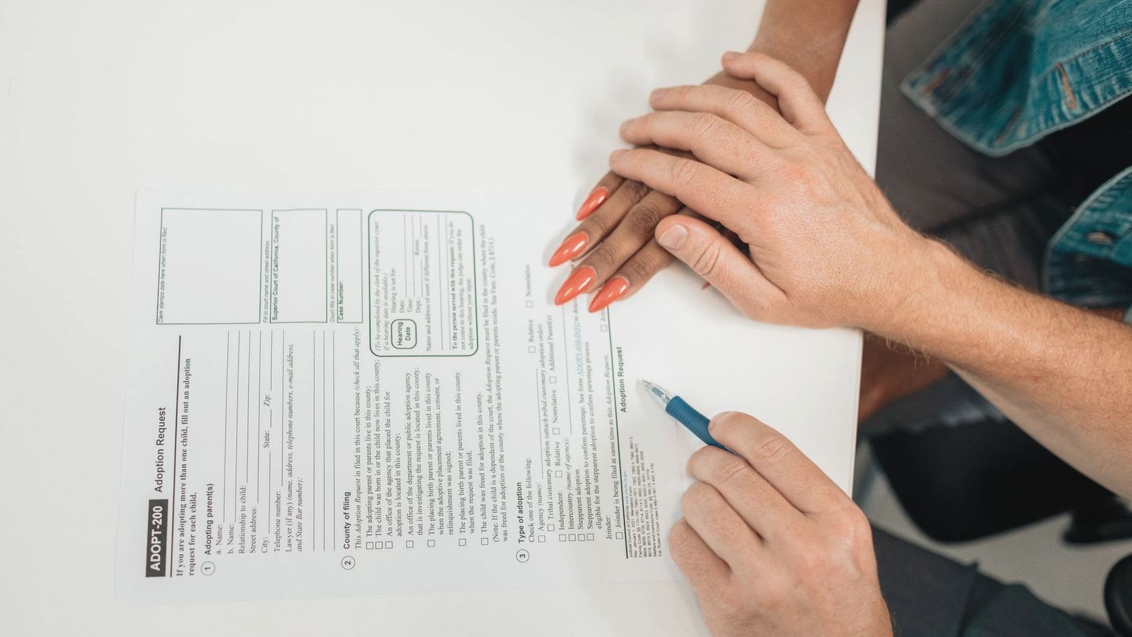 A couple fills out an adoption request form, highlighting commitment and future family planning.