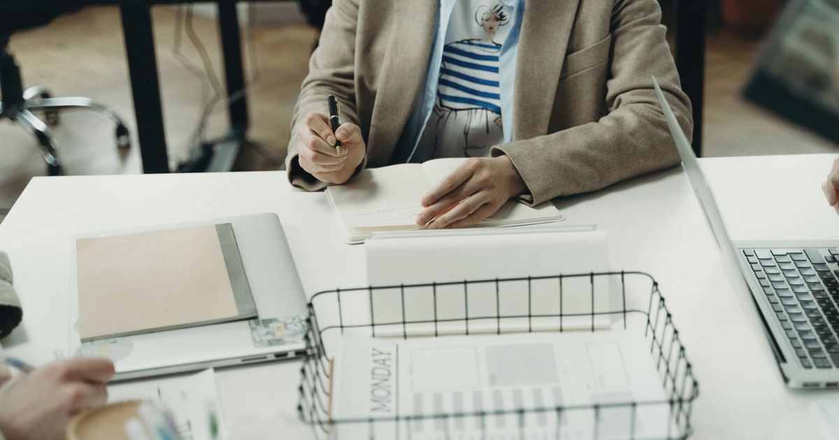 Professional office setting with a focus on planning and note-taking.