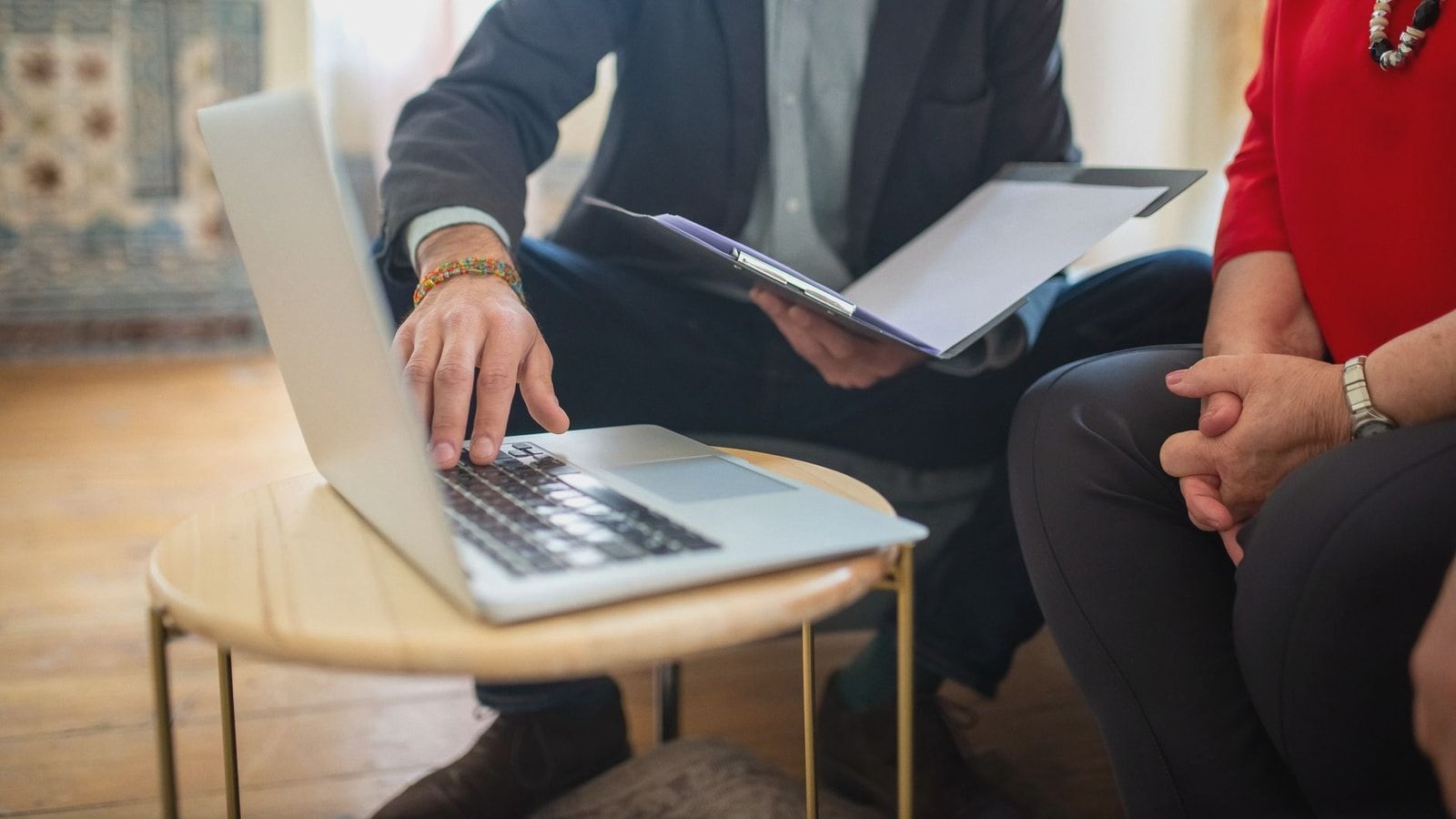 Professional meeting with a laptop and documents in an office setting.