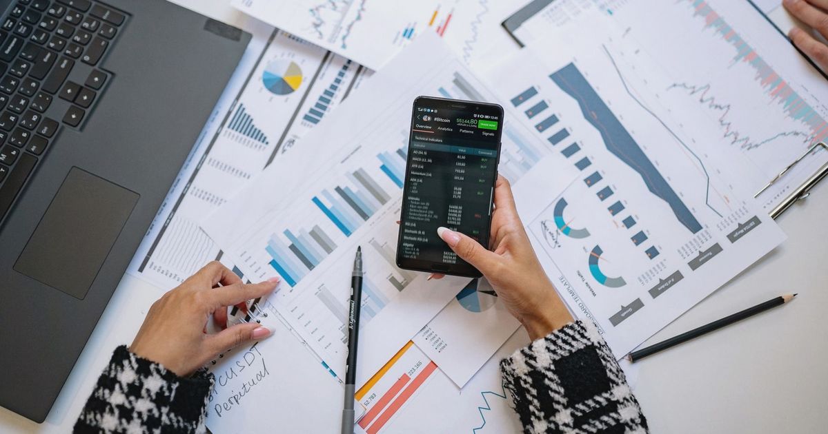 A top view on charts and smartphone in an office, showcasing data analytics.
