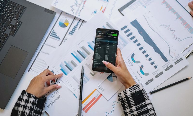 A top view on charts and smartphone in an office, showcasing data analytics.