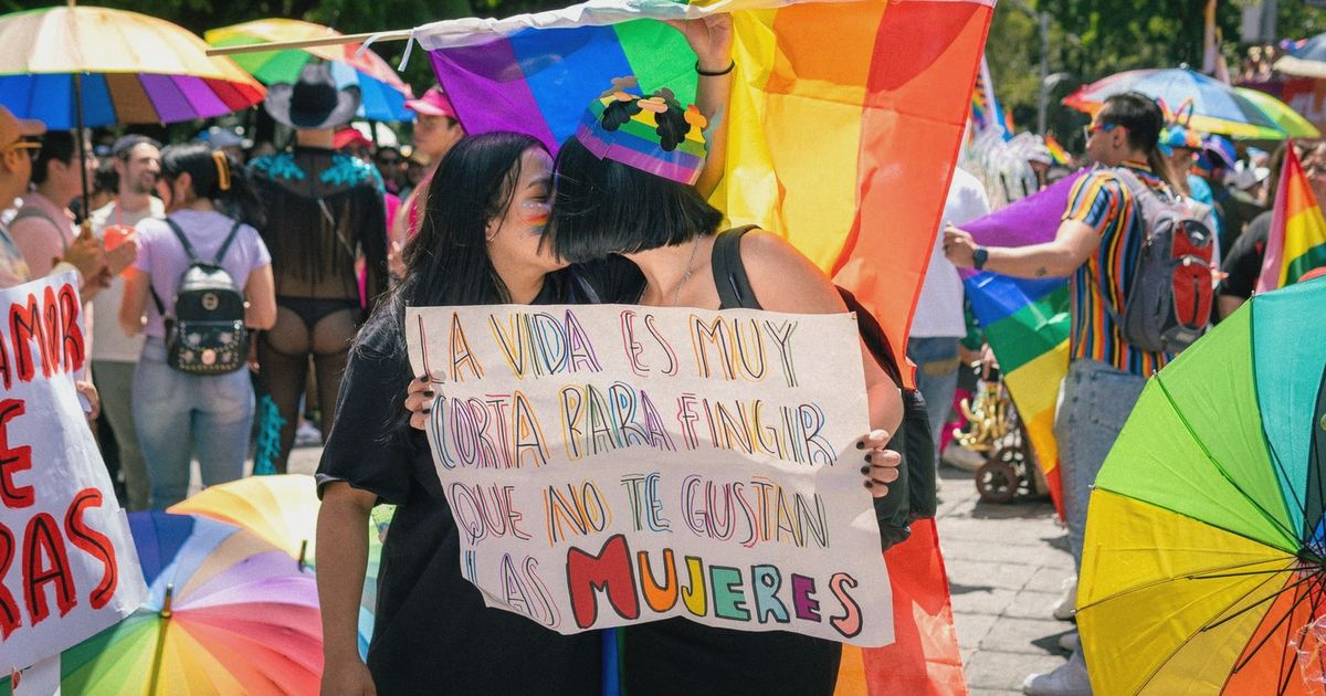 Colorful pride parade capturing joyful moments and LGBTQ+ solidarity in a sunny outdoor setting.