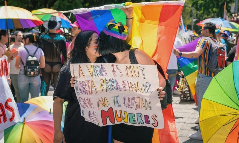 Colorful pride parade capturing joyful moments and LGBTQ+ solidarity in a sunny outdoor setting.