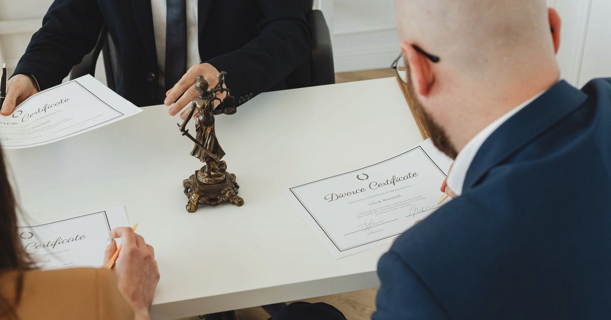 A professional setting with a focus on signing divorce documents in an office environment.