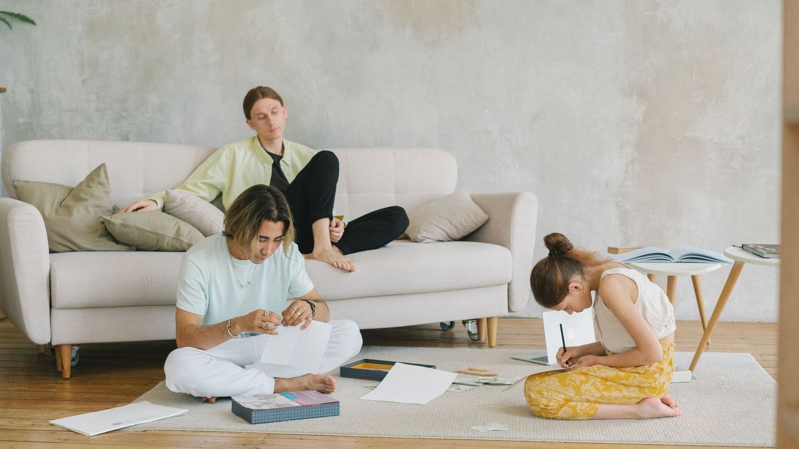 A family enjoying quality time with art and relaxation in a cozy living room setting.