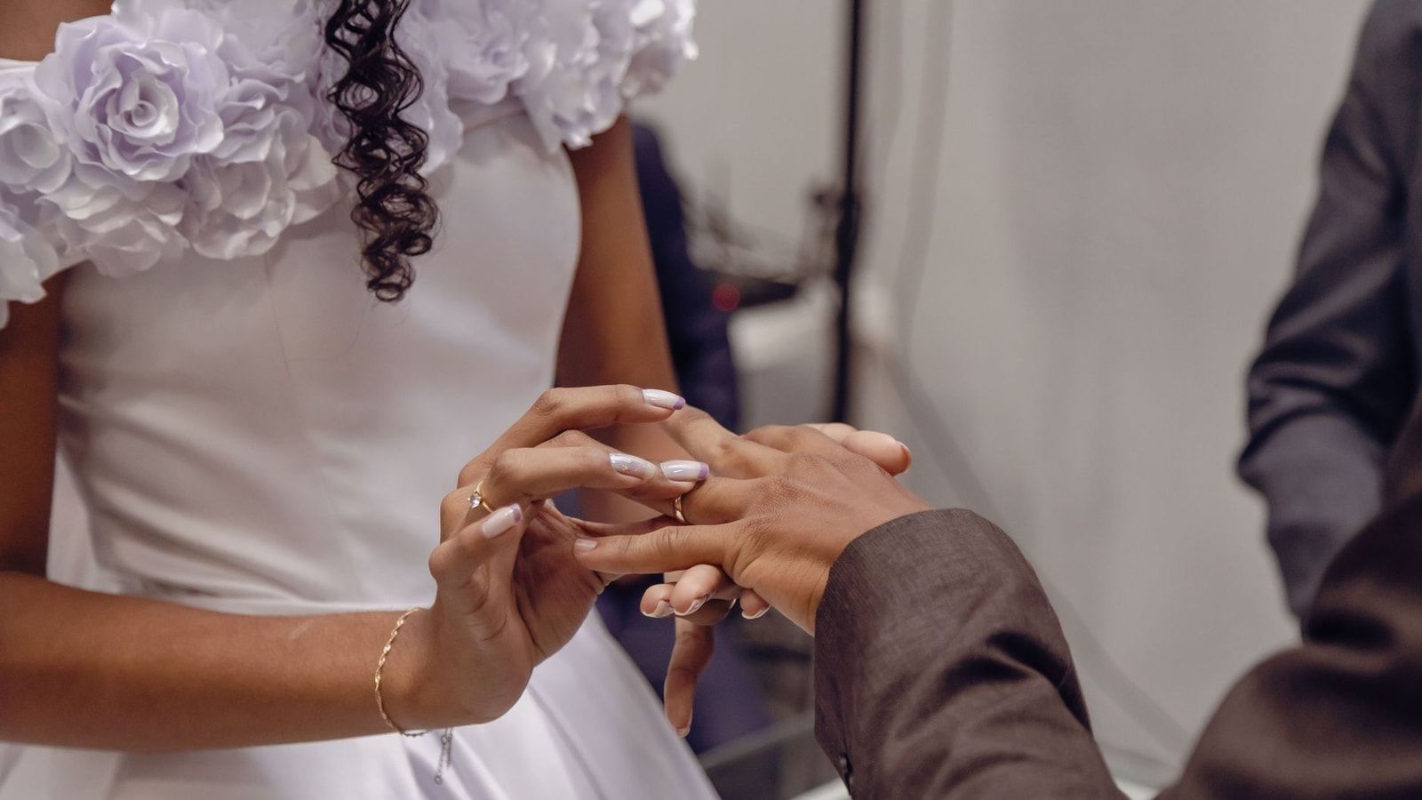 A close-up of a bride and groom exchanging wedding rings during their ceremony, showcasing love and commitment.
