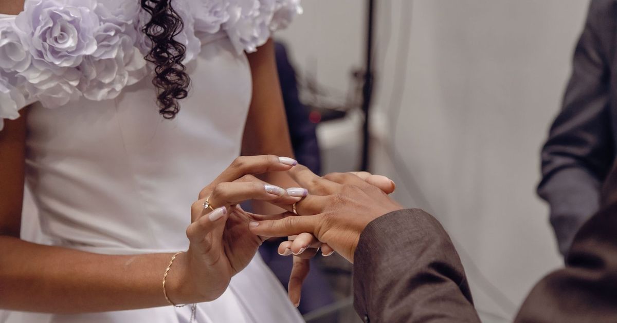 A close-up of a bride and groom exchanging wedding rings during their ceremony, showcasing love and commitment.