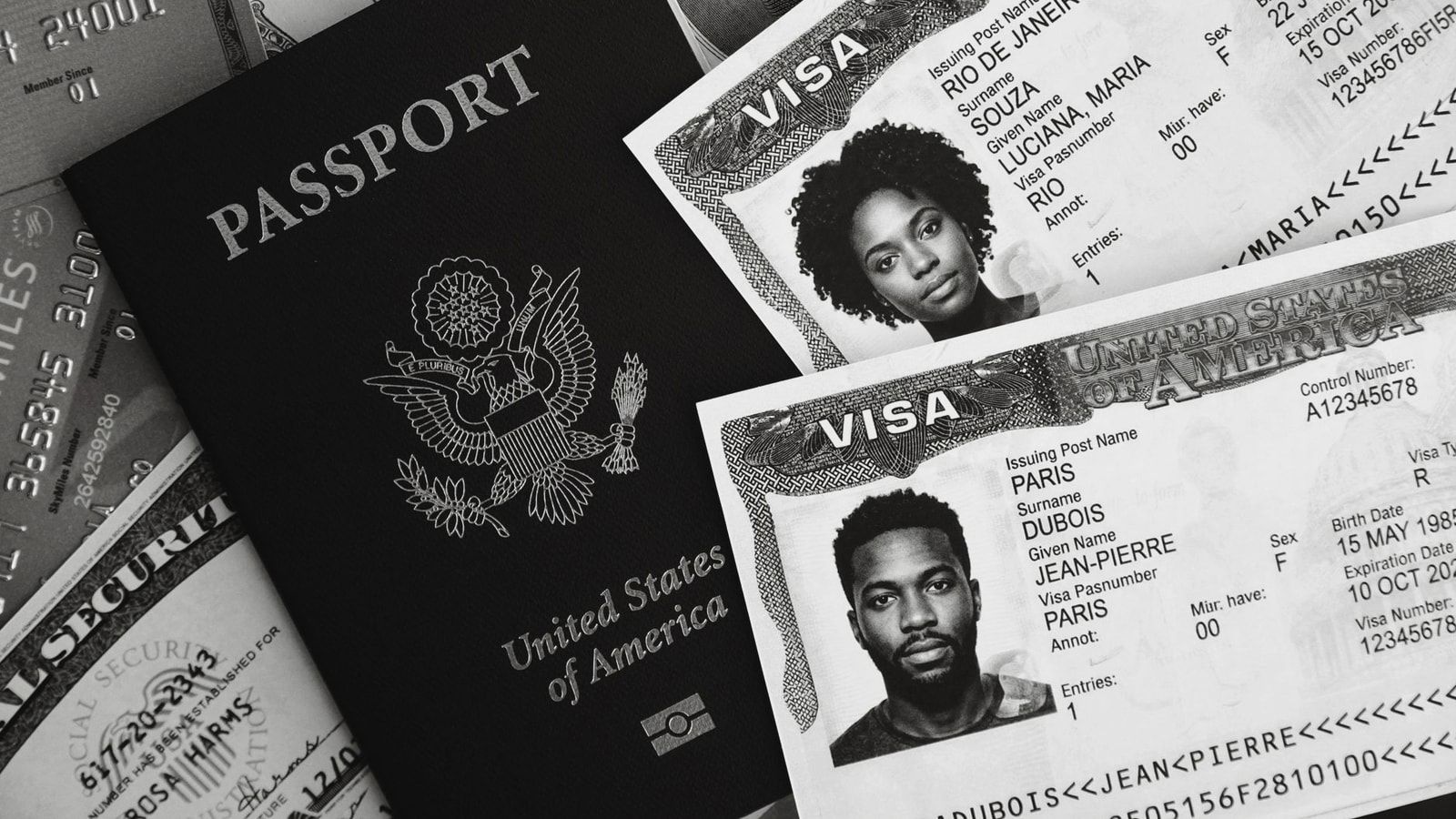Monochrome photo of a US passport, visas, and currency, symbolizing travel and finance.