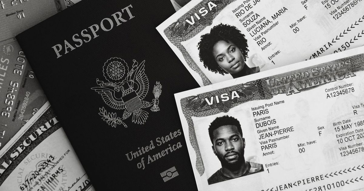 Monochrome photo of a US passport, visas, and currency, symbolizing travel and finance.
