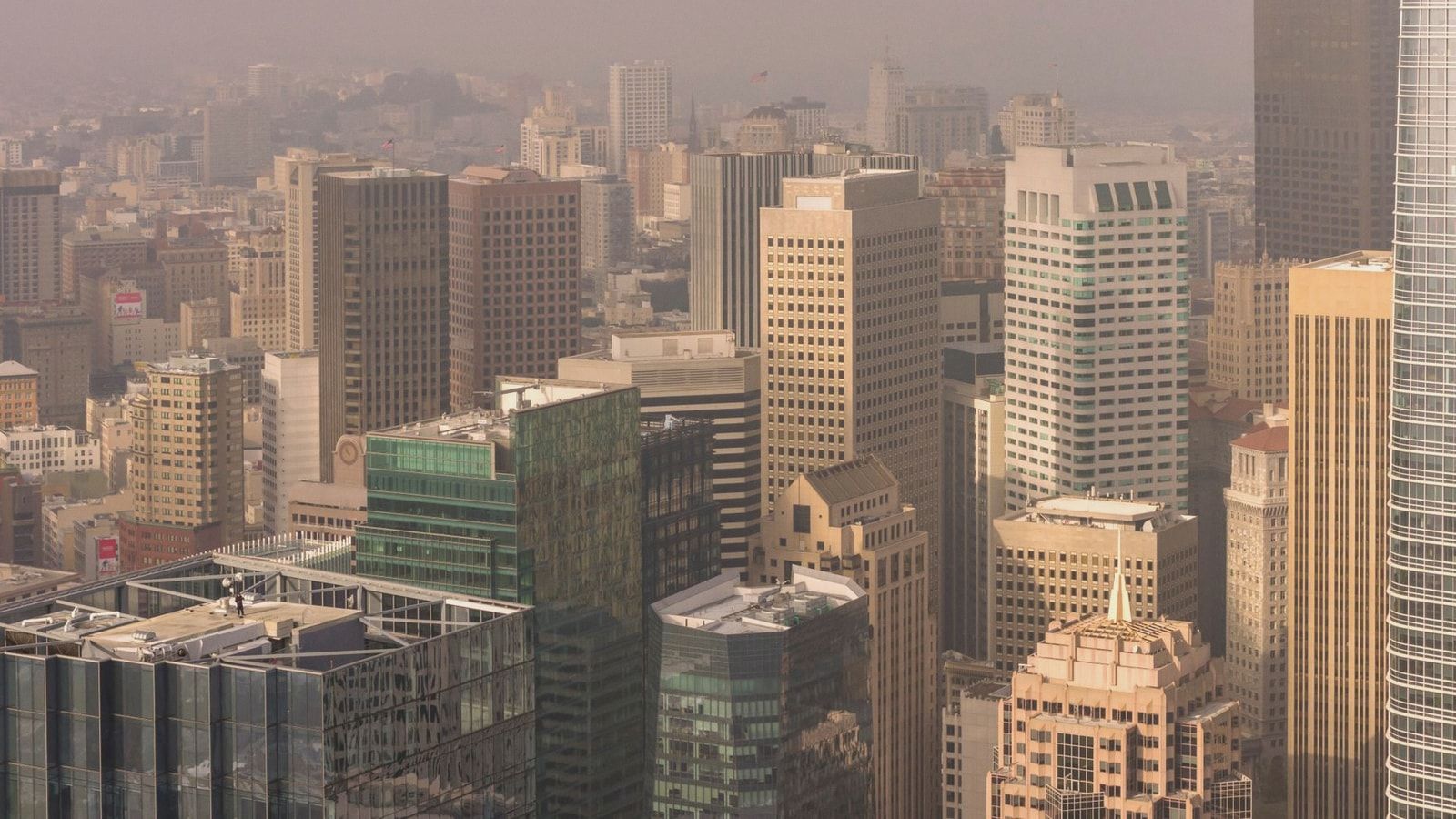 Aerial view of San Francisco skyscrapers enveloped in fog, highlighting the city's urban architecture.
