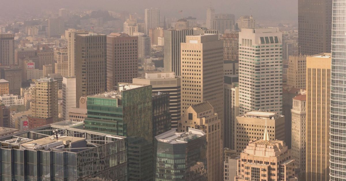 Aerial view of San Francisco skyscrapers enveloped in fog, highlighting the city's urban architecture.