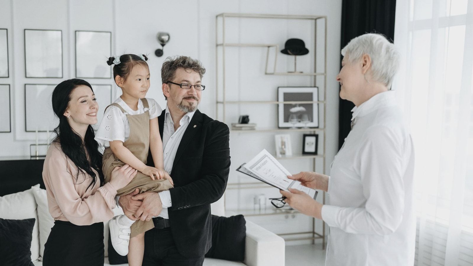 A joyful adoptive family meeting with a social worker indoors.