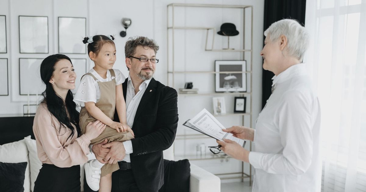 A joyful adoptive family meeting with a social worker indoors.