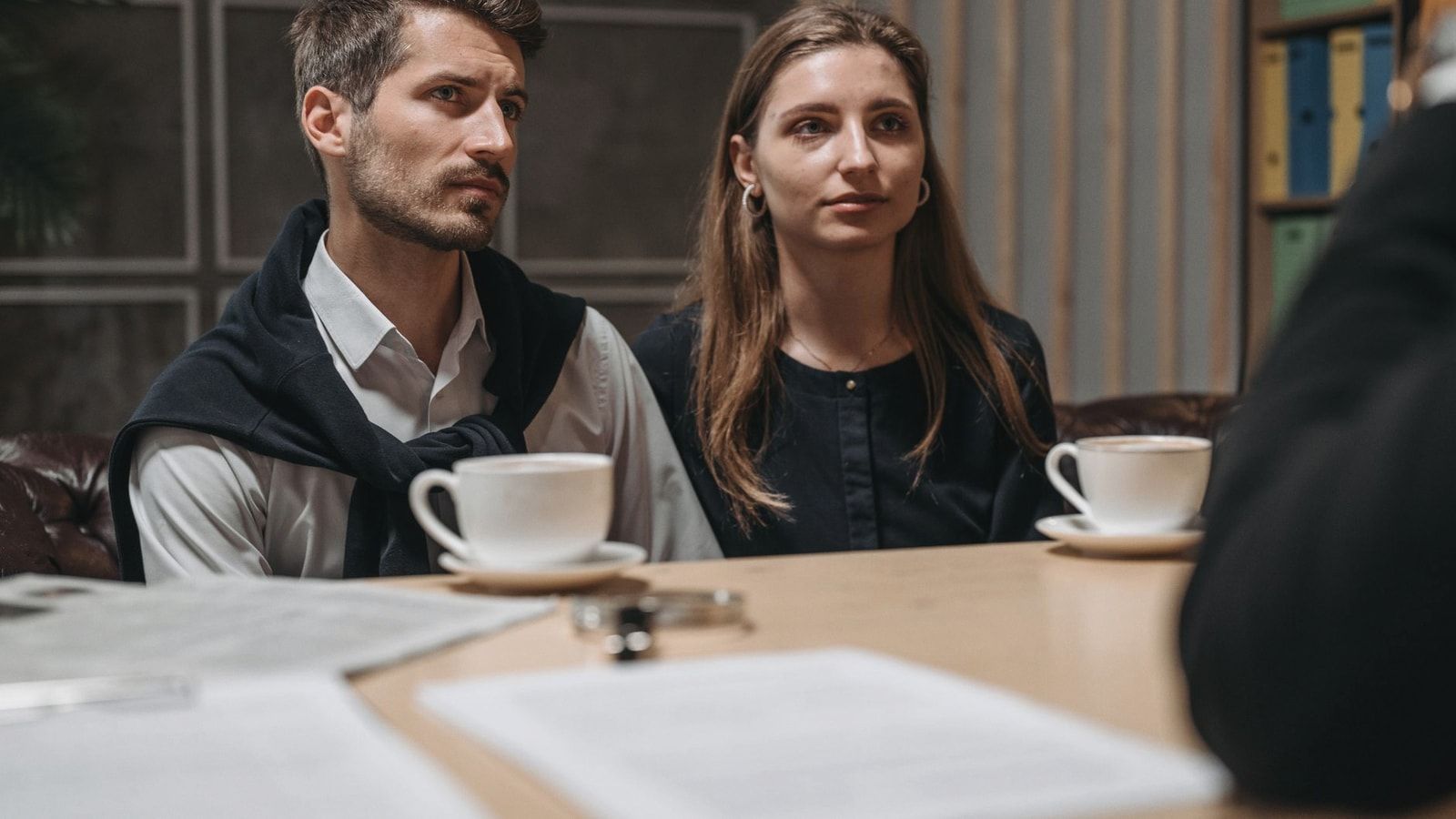 Business meeting with a couple engaging with a consultant in a modern office setting.