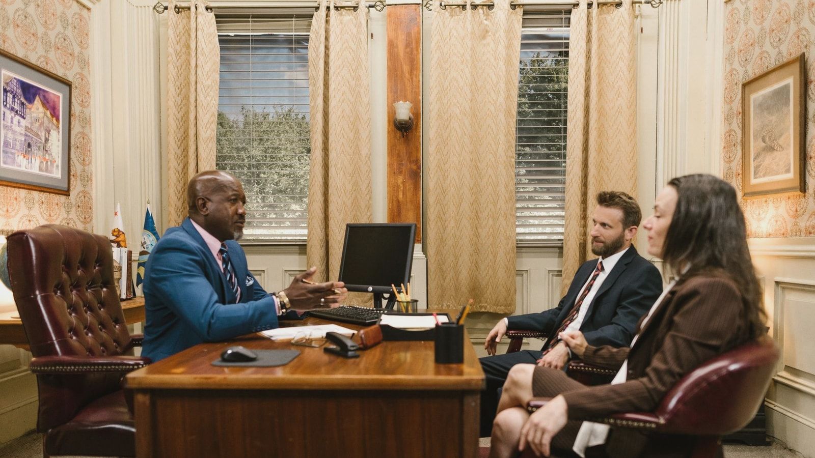 Lawyers discussing with a client in a professional office environment. Business meeting concept.
