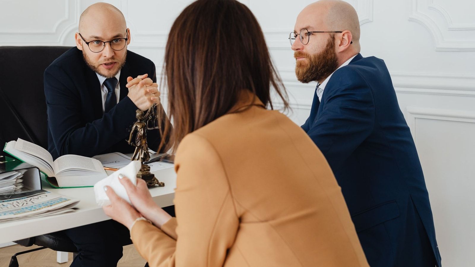 Professional discussion among lawyers in a modern office, focusing on legal matters.