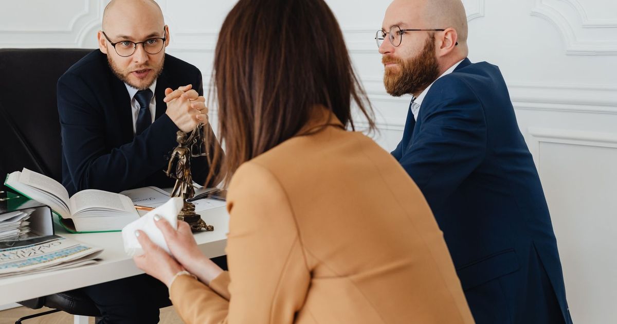 Professional discussion among lawyers in a modern office, focusing on legal matters.