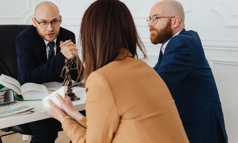 Professional discussion among lawyers in a modern office, focusing on legal matters.