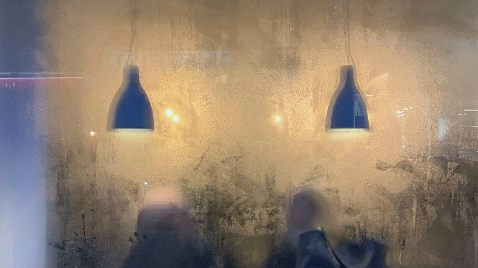 a couple of people sitting at a table with a light on top