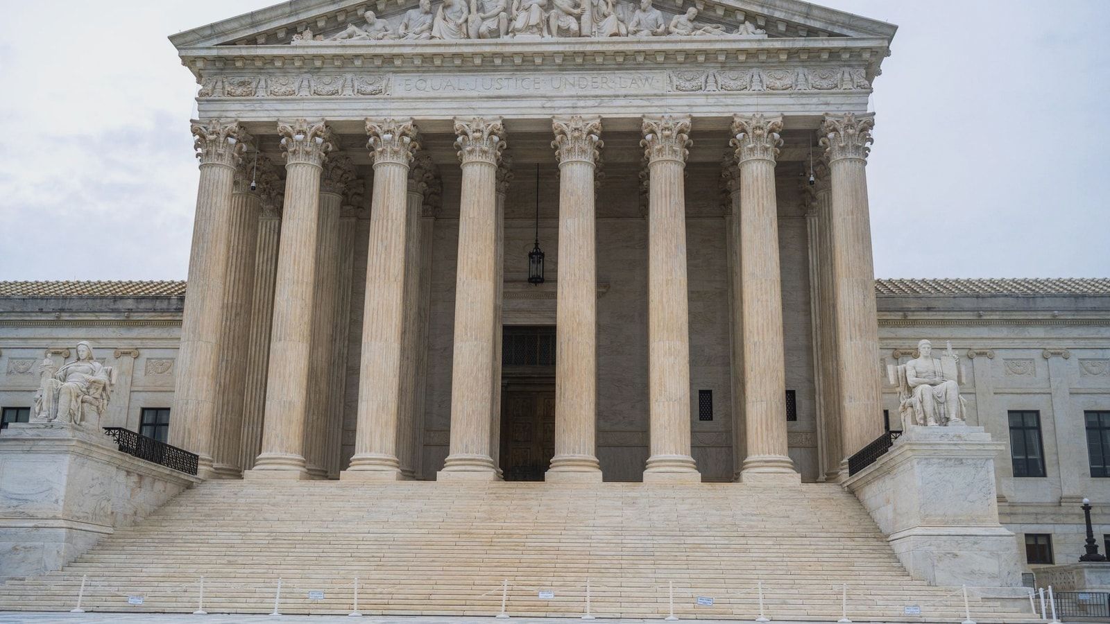 Front view of the iconic US Supreme Court building showcasing its grand columns and classic architecture.