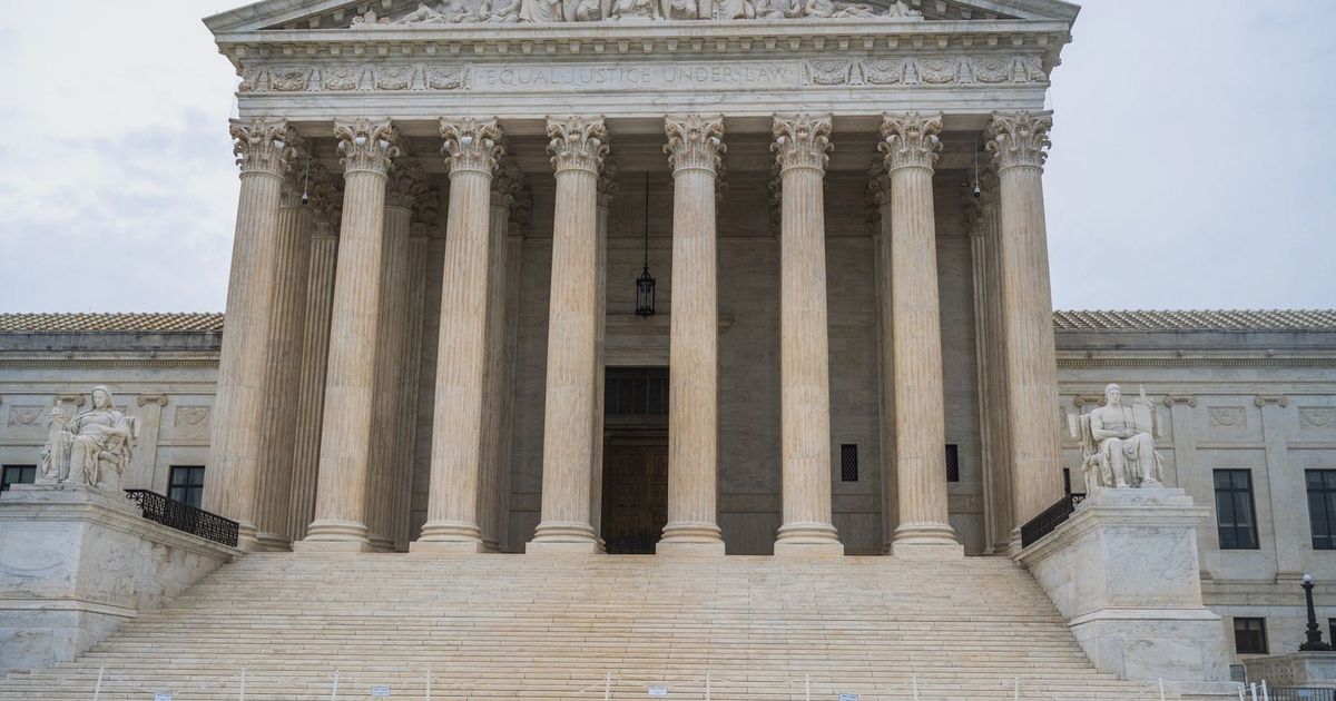 Front view of the iconic US Supreme Court building showcasing its grand columns and classic architecture.