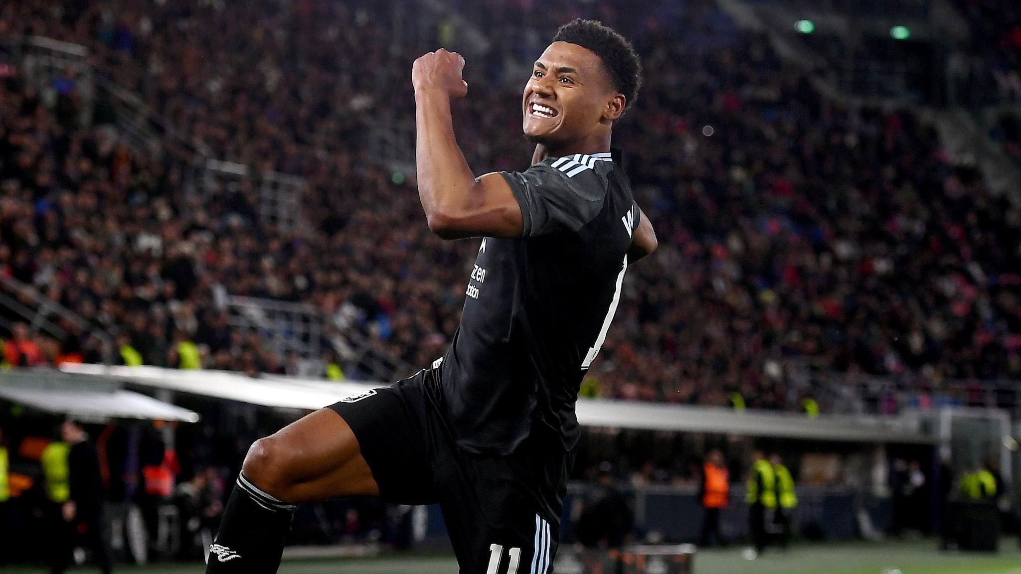 Ollie Watkins celebrates in his black kit during an Aston Villa hospitality match at the stadium.
