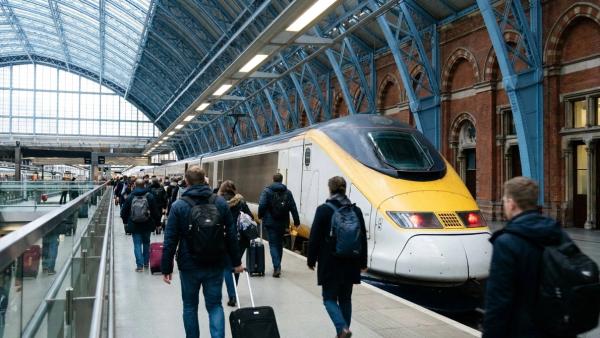 A high speed train at a London station trainshed with travellers heading for Brussels