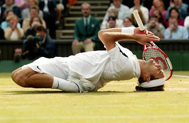 Roger Federer Wimbledon celebration: triumphant tennis player on grass court with racket.