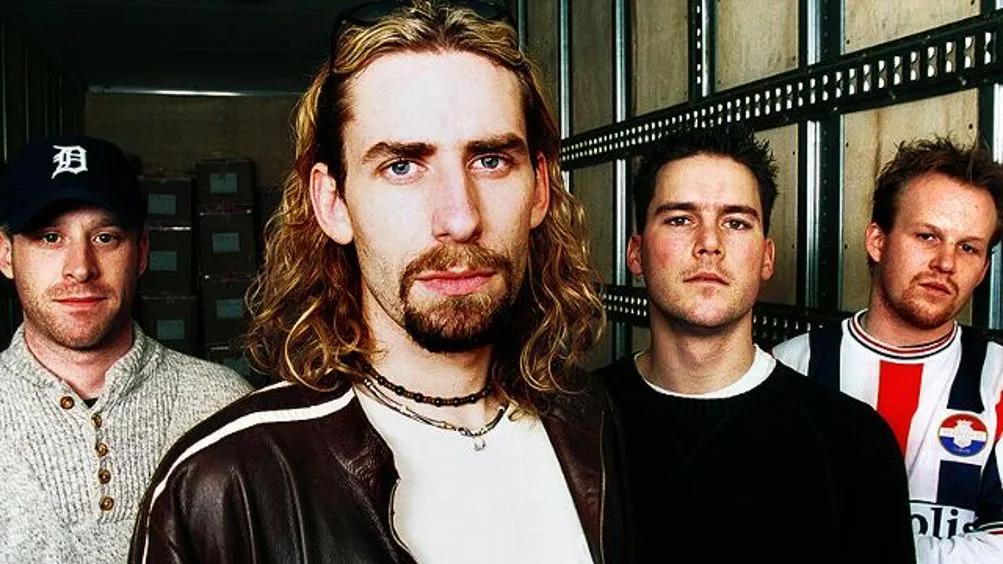 An older Nickelback band photo, Chad Kroeger with long hair and a brown leather jacket at the front
