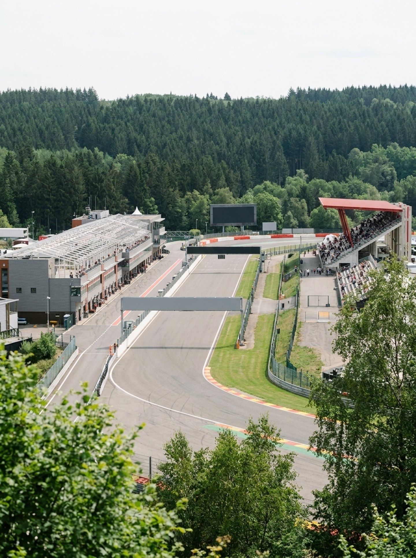 View from an open grandstand seat over the track and a giant screen at Circuit de Spa-Francorchamps