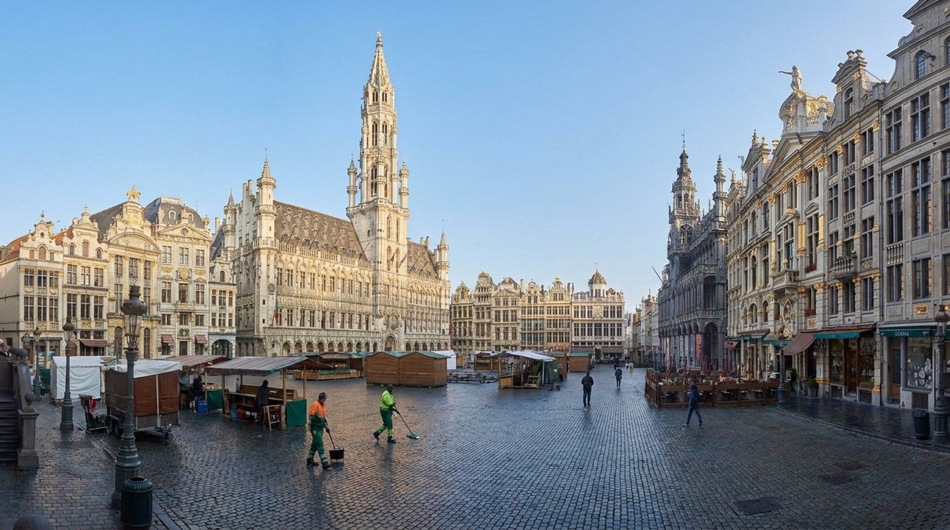 The historic Grand-Place in Brussels with gilded guild houses and the Gothic town hall spire on a clear morning