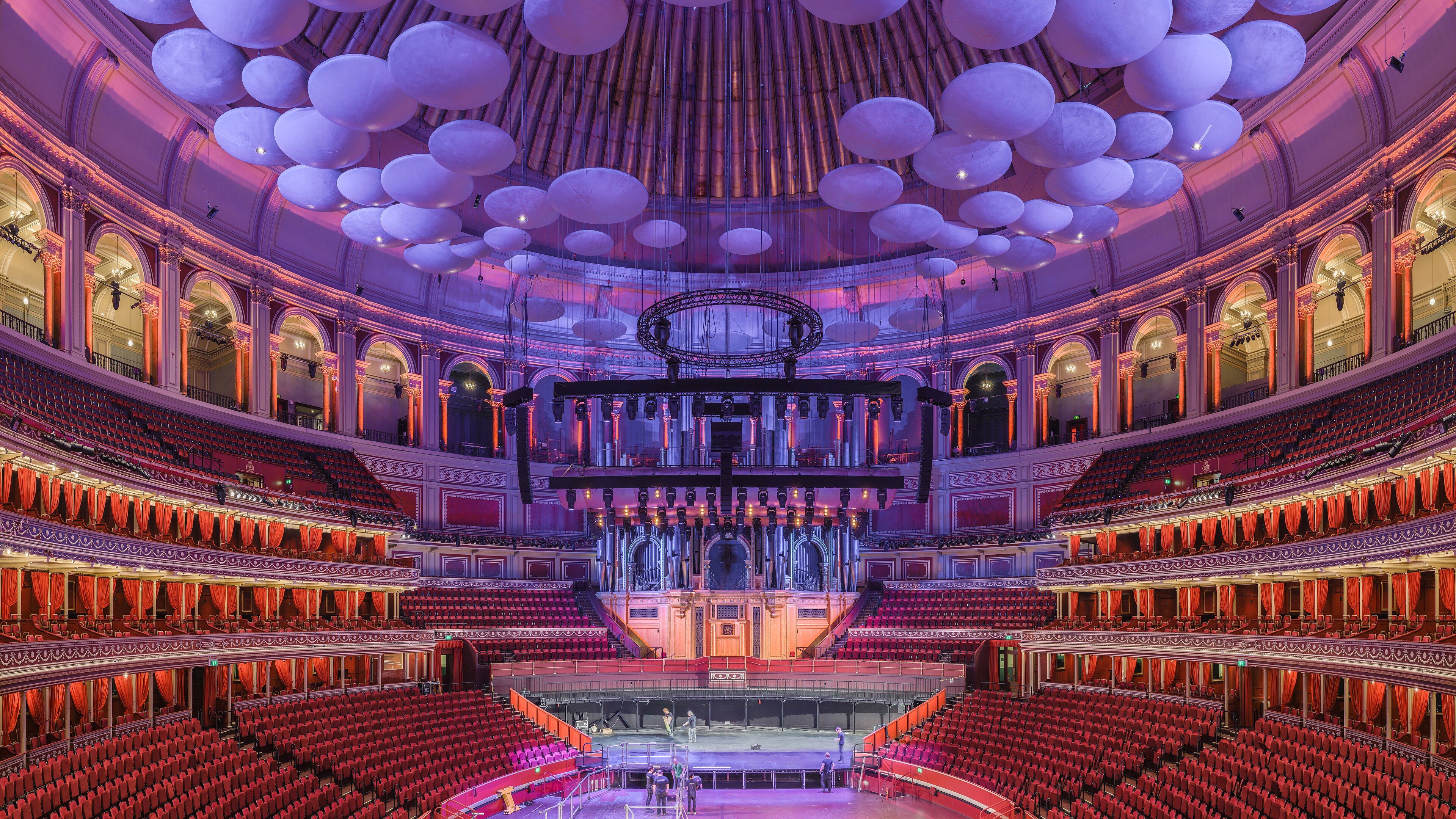 Wide view of the Royal Albert Hall auditorium and stage seen from a central box in the Grand Tier