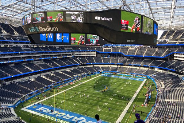 Inside SoFi Stadium during an NFL game in November 2021, with the video board hanging above the field