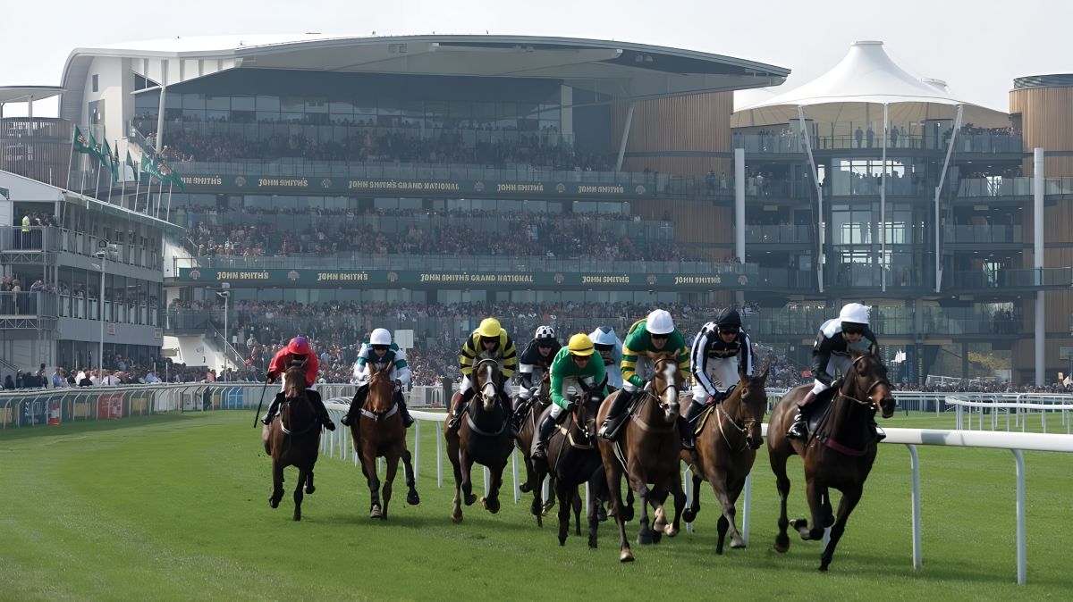 Jockeys gallop at Aintree Racecourse steeplechase with 