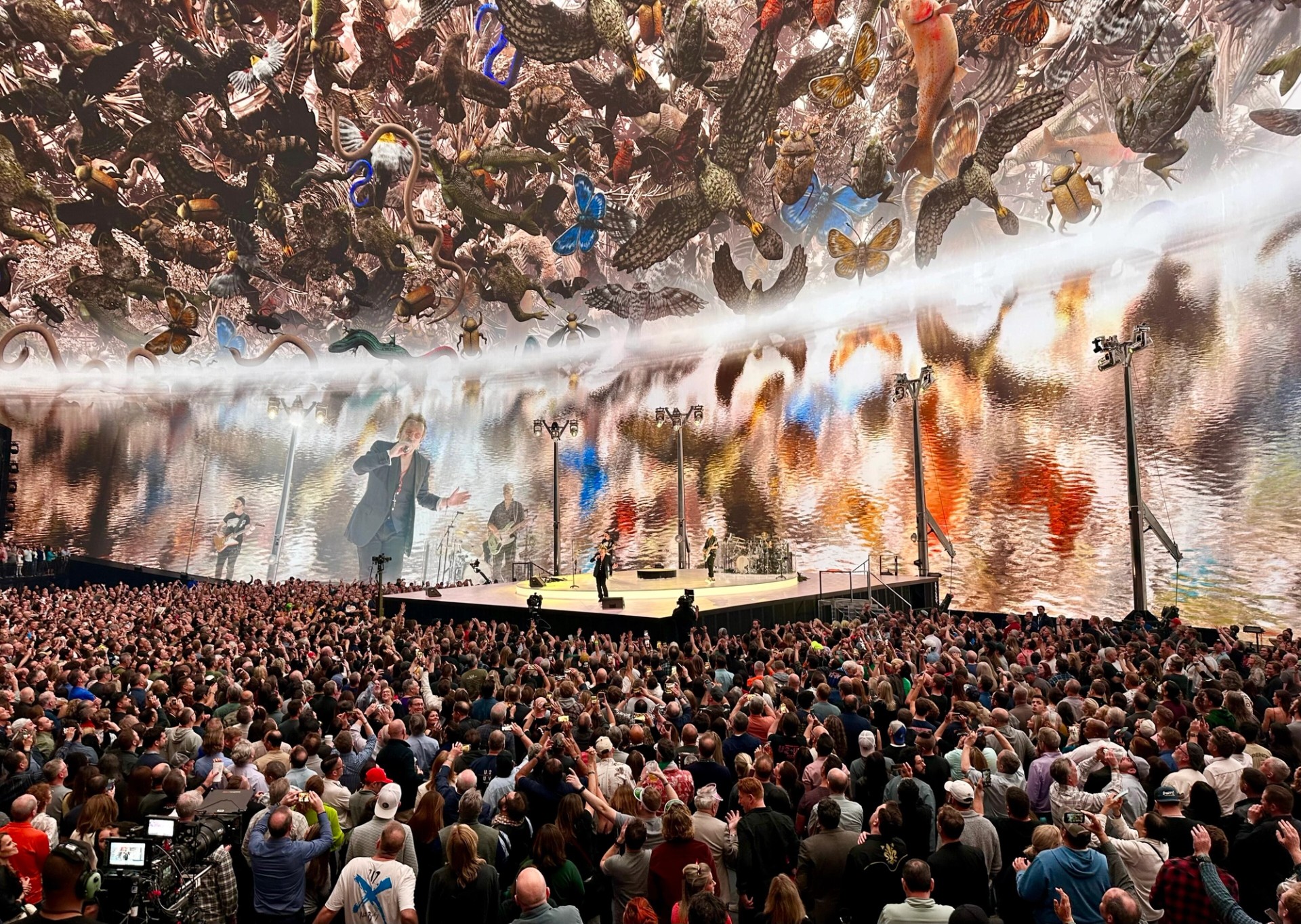 U2 performing on stage inside the Sphere in Las Vegas in February 2024, with the dome screen lit above the crowd